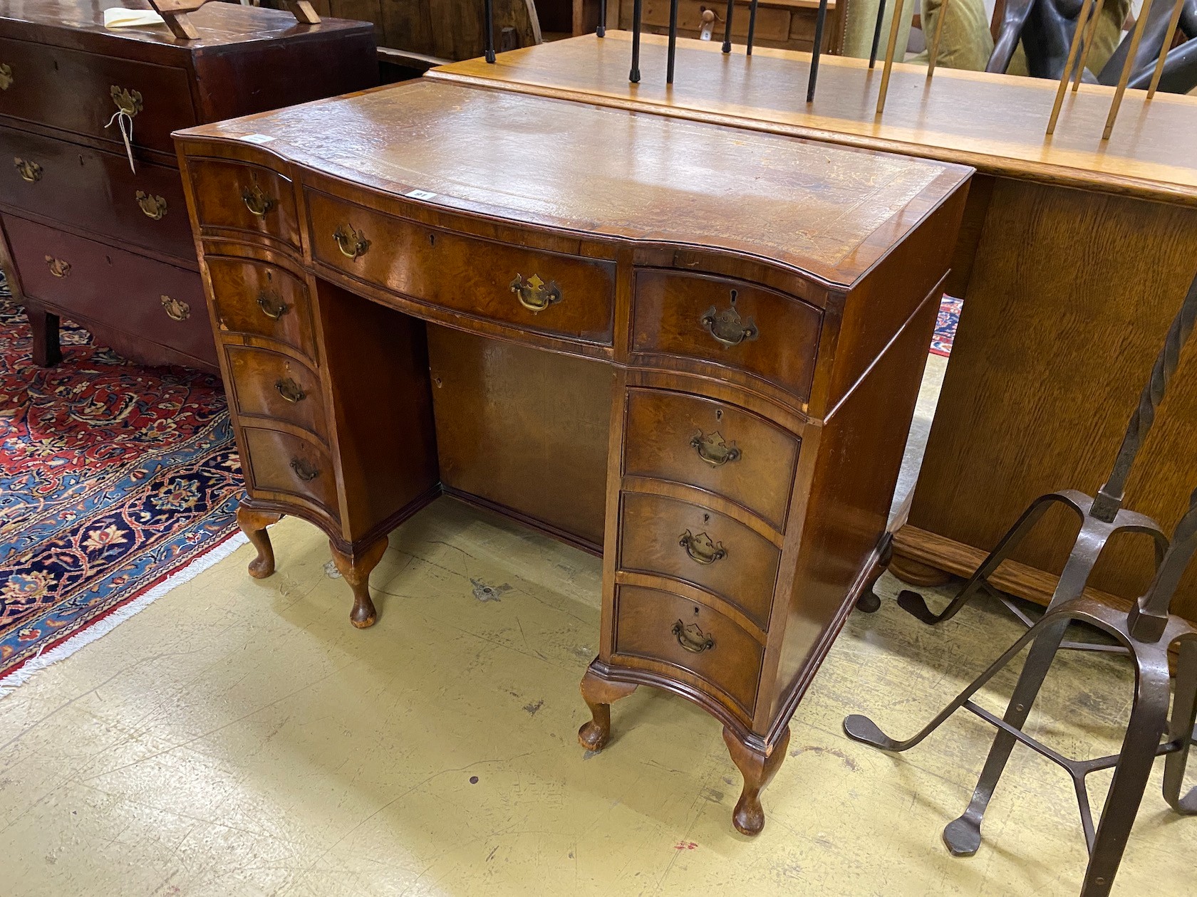 A George III style mahogany leather topped serpentine kneehole desk, length 98cm, depth 56cm, height 79cm